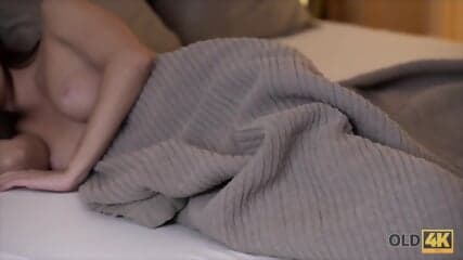 Old Husband And His Young Spouse Relax Together In Bedroom